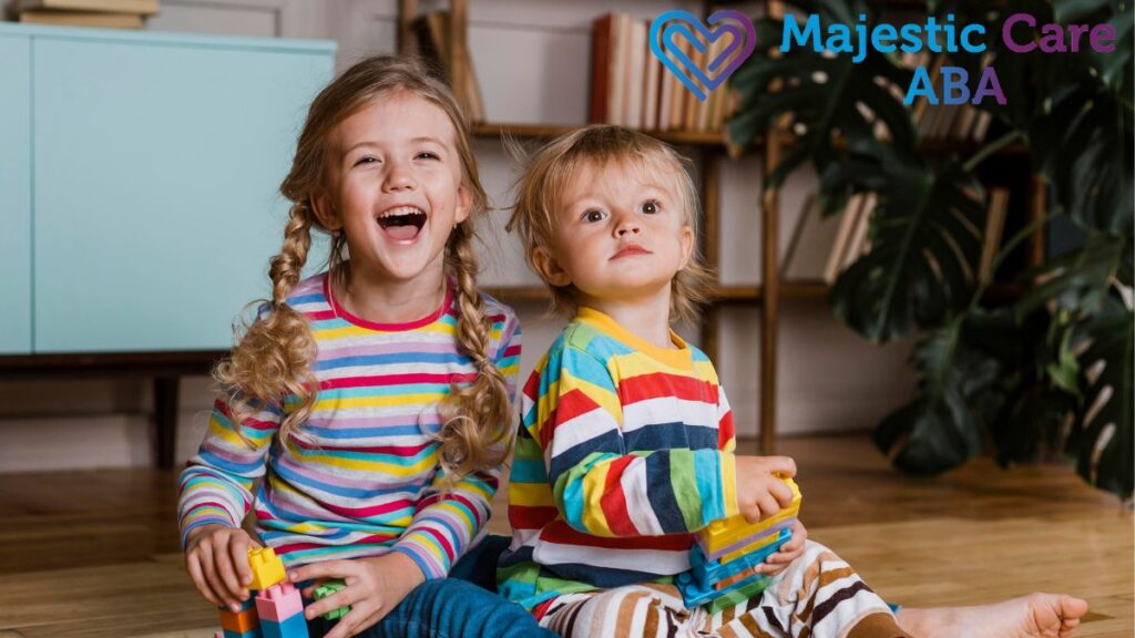 Autistic child and sibling working together with mutual support.